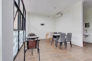 a dining room with chairs and a table in it at Capital O 93266 Palmier Hotel in Yogyakarta