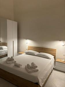 a bedroom with a large bed with towels on it at SALE E LUCE in Trapani