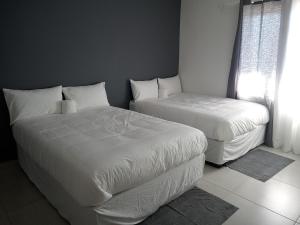 Katil atau katil-katil dalam bilik di Hidden Haven Guest House - Swakopmund NAMIBIA