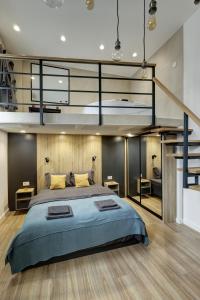 a bedroom with a large bed and a loft at Sunflower Apartment in Belgrade