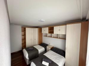 Habitación pequeña con 2 camas y armarios en Precioso apartamento en el corazón de Elizondo, en Elizondo