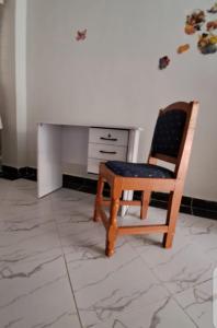 a desk and a chair in a room at Palm homes in Mutomo