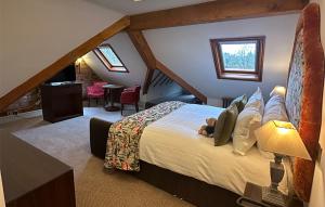 Nunsmere Hall Hotel في Oakmere: غرفة نوم مع سرير مع دمية دب عليها