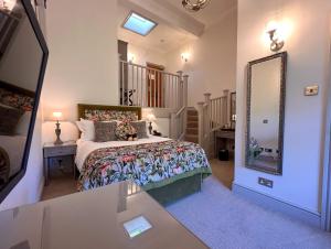 a bedroom with a bed and a large mirror at Nunsmere Hall Hotel in Oakmere