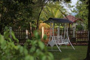 a swing set in a yard with a gazebo at Xotic Resort Upper Floor in Kurunegala