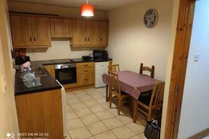 a kitchen with a table and a table and a dining room at Townhouse 1 Barrow Lane in Bagenalstown