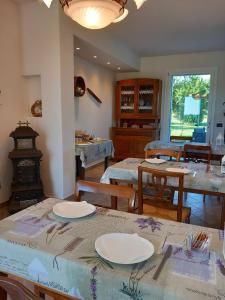 a dining room with tables and chairs and a stove at La collinetta B&B in Crespellano