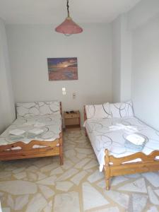 Ένα ή περισσότερα κρεβάτια σε δωμάτιο στο Apartments Stilos Ioannis