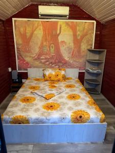 a bedroom with a bed with flowers on it at Pensiunea Alessia Murighiol in Murighiol