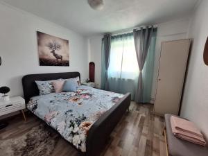 a bedroom with a bed and a window at Hellen Studio Predeal in Predeal