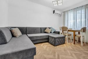 a living room with a couch and a table at Sam's Apartment in Berat