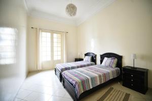 a bedroom with a bed and a window at COSY Art Deco Apart in Casablanca