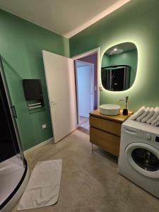 a bathroom with a sink and a washing machine at Appartement Le 96 in Lurcy-Lévis +3 photos