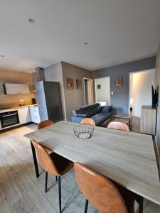 a kitchen and living room with a table and chairs at Appartement Le 96 in Lurcy-Lévis