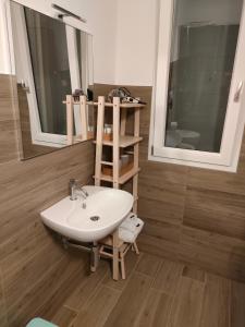 a bathroom with a sink and a mirror at B&B il Santo in Castelleone di Suasa