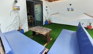 a patio with blue chairs and a table at SK Stay-Condo in The Soul with private terrace 300m Paje Beach in Paje