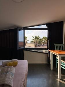 a room with a bed and a table and a window at Saint Tropez Durres in Durrës