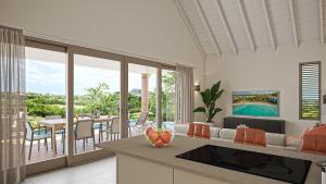 a kitchen and living room with a view of the ocean at Blue Bay Curaçao Golf & Beach Resort in Willemstad