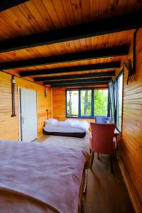 a bedroom with two beds and a red chair at Bungalow green love sapanca in Sapanca