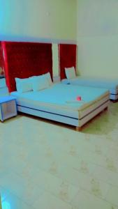 a bedroom with a large bed in a room at Malinum Grande Guest House in Lahore