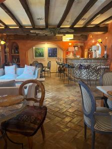 a living room with couches and chairs and a bar at Hotel Casa Henrietta in Jimena de la Frontera