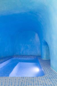 a large swimming pool in a blue room at Captain's house suites in Vóthon