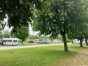 a group of rvs parked next to a road at Polzer CAMPING BÜKFÜRDŐ in Bük