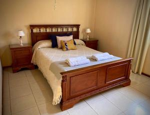 a bedroom with a bed with two pillows on it at Departamento "Soft & Central" in Tunuyán