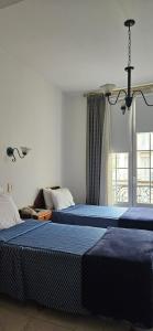 sypialnia z 2 łóżkami i oknem w obiekcie Astoria Hotel w BuenosAires