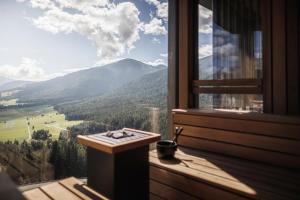 a room with a window with a view of a mountain at Alpin Panorama Hotel Hubertus in Valdaora