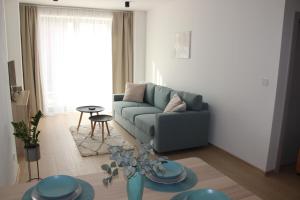 a living room with a couch and a table at Apartmán POD ROTUNDOU in Skalica