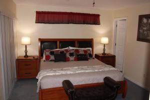 a bedroom with a bed with two lamps and a chair at Disney Villa Magical Retreat Private Pool, LakeView & Game Room in Kissimmee +110 photos