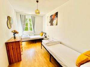 a room with two beds and a window at Stötteritz Holiday Apartment - 3 Rooms - 6 People - 5 beds - Balcony - Great public transport 11 minutes to the city in Leipzig