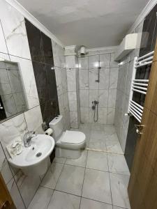 a bathroom with a toilet and a sink at Anatolia SUITE APART in Bostancı