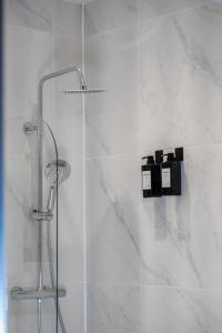 a shower with a glass door in a bathroom at Short Stays, Free Parking, Contractors, Families - Large Home in Durham