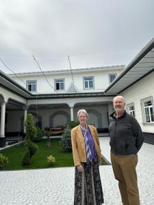 two older people standing in front of a house at RISHTAN Guest House RISHTON 