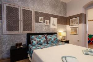 a bedroom with a large bed in a room at Sunrise balcony in Sifnos