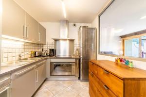 a kitchen with a sink and a refrigerator at 3-bedroom flat in the city centre in Chamonix