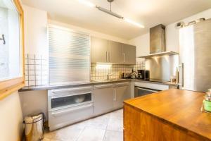 a kitchen with stainless steel appliances and a wooden counter at 3-bedroom flat in the city centre in Chamonix