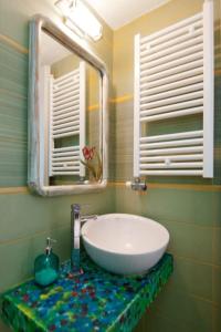 a bathroom with a sink and a mirror at Sunrise balcony in Sifnos