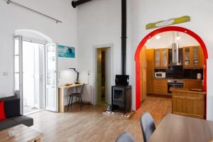 a living room with an arch in the middle of a room at Sunrise balcony in Sifnos +39 photos