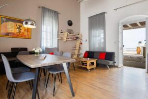 a dining room and living room with a table and chairs at Sunrise balcony in Sifnos