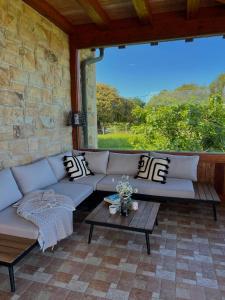 a couch sitting on a patio with a table at Villa Artegoikoa in Ibarrangelu