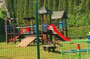 a playground with a roller coaster and a slide at Dom Wakacyjny U BARBASI - 7 DNI W DOBREJ CENIE ! in Chmielno +33 photos