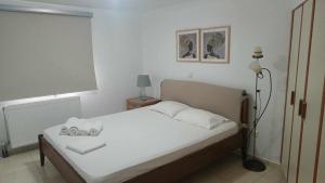 a bedroom with a bed with two towels on it at Melina Apartment - Akoumia Village in Akoumia +28 photos