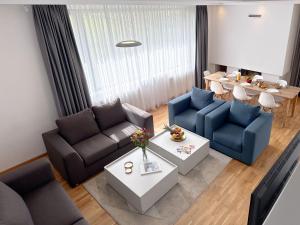 a living room with two couches and a table at Poljine Hills in Poljine