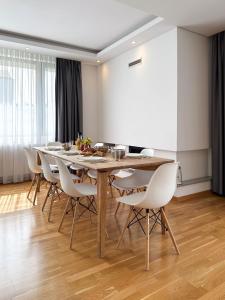 a dining room with a table and white chairs at Poljine Hills in Poljine +32 photos