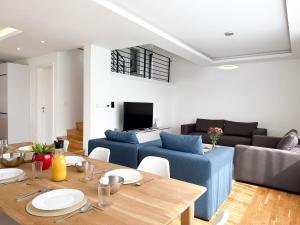 a living room with a table and a blue couch at Poljine Hills in Poljine