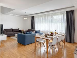a living room with a table and a blue couch at Poljine Hills in Poljine