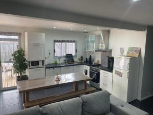 a large kitchen with a wooden table in it at L'Imprévu est une maison individuelle. in Sennecey-le-Grand